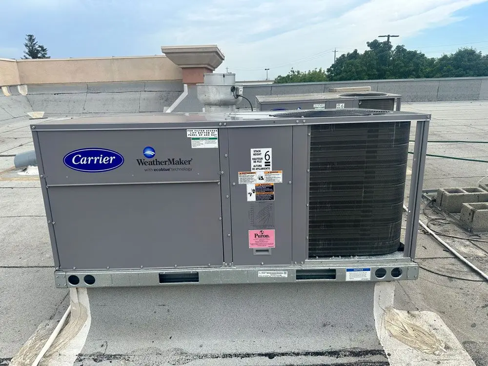 Carrier WeatherMaker rooftop packaged HVAC unit installed on a flat commercial roof